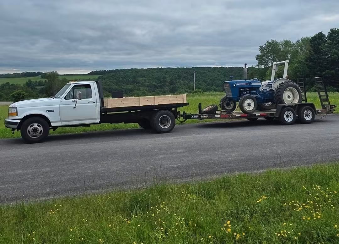 Tractor on the equipment trailer behind the Harris Haulers flatbed